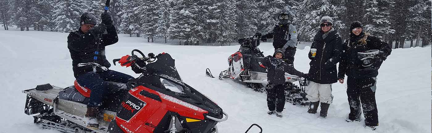family on snowmobiles